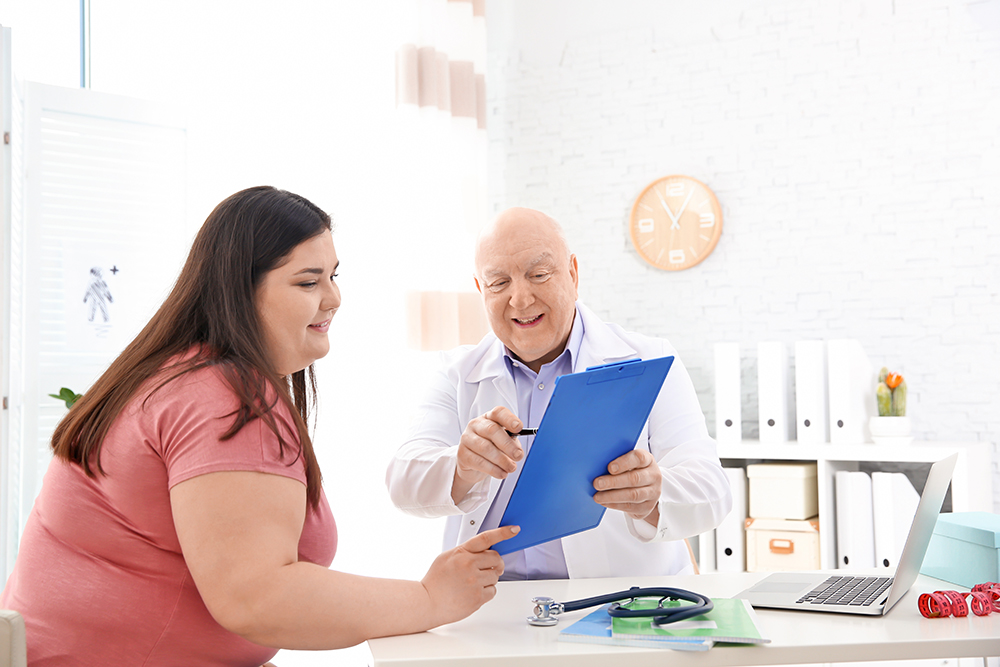 Doctor going through weight loss options with patient.