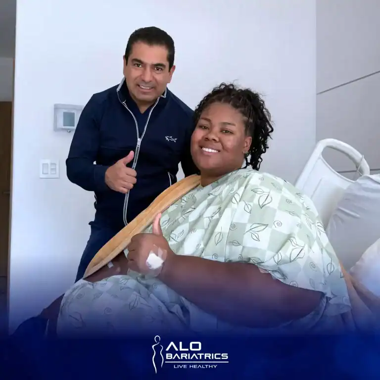 Dr. Alejandro López beside a seated patient in the hospital room the day after surgery